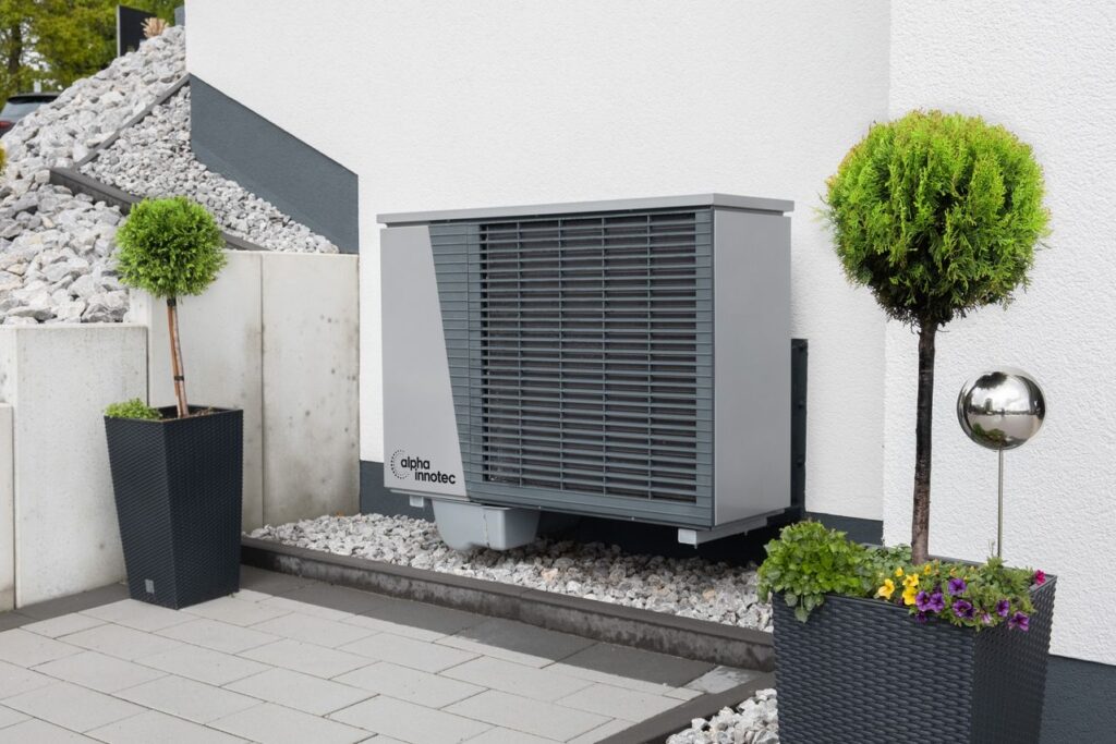 Modern air conditioning unit with flower pots and sleek decor outdoors
